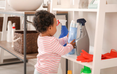 Baby playing with cleaning supplies