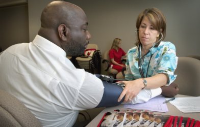 Nurse taking patient's blood pressure