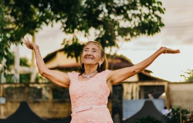 Elderly woman happily dancing